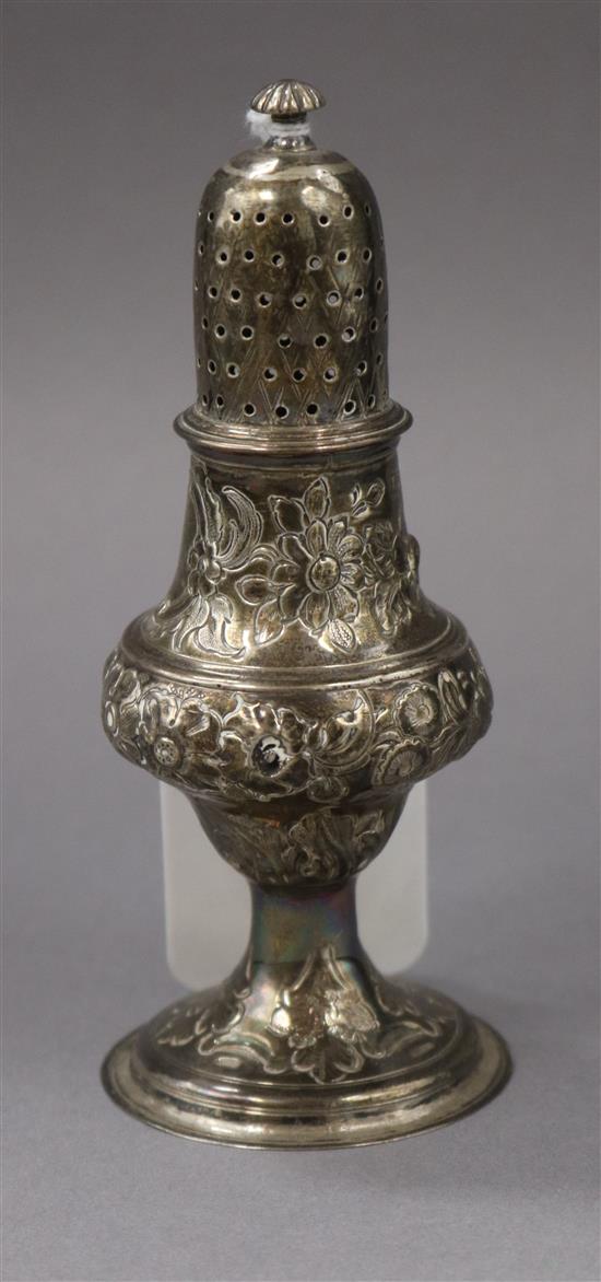 A George III embossed silver caster/pepperette, Samuel Davenport?, London, 1789, 13.3cm.